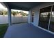 Covered patio with view of backyard, grass, and white fence at 6051 Sacred Oak Ave, Mount Dora, FL 32757