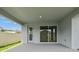 Covered patio with access to the backyard through a door and sliding glass door, extending living space outdoors at 6051 Sacred Oak Ave, Mount Dora, FL 32757