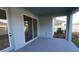 Covered patio with painted concrete flooring and sliding glass doors at 6051 Sacred Oak Ave, Mount Dora, FL 32757