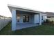 Covered patio with sliding glass doors, view of backyard, and AC unit at 6051 Sacred Oak Ave, Mount Dora, FL 32757