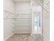 Spacious walk-in closet with wire shelving and carpeting extending into the adjacent hallway at 6051 Sacred Oak Ave, Mount Dora, FL 32757