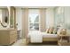 Cozy bedroom with natural light, showcasing a neat bed, desk, and soothing color palette at 1303 Blue Ash Ln, Deland, FL 32720