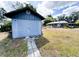 View of backyard with storage shed and quaint home in the background, offering ample space for outdoor activities at 1690 S Mcadoo Ave, Bartow, FL 33830