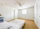 Bright bedroom featuring neutral carpet and decor with a ceiling fan, window, and closet at 1690 S Mcadoo Ave, Bartow, FL 33830