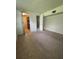 Bedroom features neutral carpet and open closet with shelving and access to a bathroom at 1690 S Mcadoo Ave, Bartow, FL 33830
