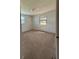 Cozy bedroom with neutral carpet, two windows providing natural light, and a clean, minimalist aesthetic at 1690 S Mcadoo Ave, Bartow, FL 33830