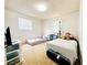 Spacious bedroom featuring neutral carpet, bright window, and 2 beds with light patterned bedding at 1690 S Mcadoo Ave, Bartow, FL 33830