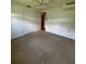 Bedroom featuring neutral carpet, closet, and a view into the hallway and hardwood flooring beyond at 1690 S Mcadoo Ave, Bartow, FL 33830