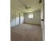 Bright bedroom featuring neutral carpet, a ceiling fan, and a window with natural light at 1690 S Mcadoo Ave, Bartow, FL 33830
