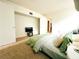 Bedroom with bright window, neutral carpet, open closet, and green quilt on bed at 1690 S Mcadoo Ave, Bartow, FL 33830