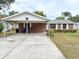 Charming single-story brick home featuring a covered carport and well-maintained landscaping at 1690 S Mcadoo Ave, Bartow, FL 33830