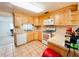 Functional kitchen with wooden cabinets, tile flooring, and essential appliances at 1690 S Mcadoo Ave, Bartow, FL 33830