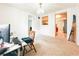 Open-plan living room featuring neutral carpet, bright window, and direct access to the kitchen at 1690 S Mcadoo Ave, Bartow, FL 33830