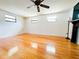 Spacious living room features wood floors, light colored walls, and natural light from multiple windows at 1690 S Mcadoo Ave, Bartow, FL 33830