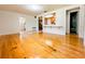 Sun-drenched living area showcasing wood floors and a seamless flow into the kitchen at 1690 S Mcadoo Ave, Bartow, FL 33830
