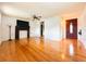Bright living room with hardwood floors, a decorative fireplace, and a stylish front door at 1690 S Mcadoo Ave, Bartow, FL 33830