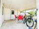 Covered porch featuring an outdoor table with 4 chairs, a bicycle, and a white paneled ceiling at 1690 S Mcadoo Ave, Bartow, FL 33830