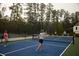 People are playing pickleball on an outdoor court with a net at 16958 Cedar Valley Cir, Clermont, FL 34711