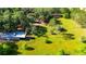 Expansive property showcasing mature trees, grassy fields, and various outbuildings at 1836 Cr 609B, Bushnell, FL 33513