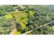 Aerial view of property showing boundary, home, outbuildings, and surrounding greenery at 1836 Cr 609B, Bushnell, FL 33513