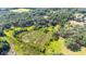 Aerial view of property showing boundary, home, outbuildings, and surrounding greenery at 1836 Cr 609B, Bushnell, FL 33513