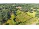 Aerial view of property showing boundary, home, outbuildings, and surrounding greenery at 1836 Cr 609B, Bushnell, FL 33513