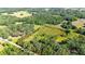 Aerial view of property showing boundary, home, outbuildings, and surrounding greenery at 1836 Cr 609B, Bushnell, FL 33513