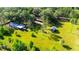 Aerial view of property showing home, outbuildings, large yard, and mature trees at 1836 Cr 609B, Bushnell, FL 33513
