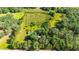Aerial view of property showing boundary, home, outbuildings, and surrounding greenery at 1836 Cr 609B, Bushnell, FL 33513