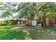 Exterior view of barn with trees, shed, and grassy area perfect for storing equipment at 1836 Cr 609B, Bushnell, FL 33513