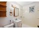 Simple bathroom featuring white tile shower, toilet, and a vanity sink at 1836 Cr 609B, Bushnell, FL 33513