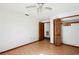 Clean bedroom with laminate flooring, wood trim and a built-in closet for easy organization at 1836 Cr 609B, Bushnell, FL 33513