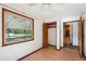 Cozy bedroom with laminate floors, closet, and view to the outside greenery through a window at 1836 Cr 609B, Bushnell, FL 33513
