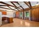 Spacious living room featuring wood walls, wood flooring, exposed beams, and natural light at 1836 Cr 609B, Bushnell, FL 33513