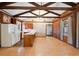 Open-concept kitchen and living room with wood flooring, exposed beams, and lots of natural light at 1836 Cr 609B, Bushnell, FL 33513