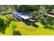 Aerial view of a large outbuilding surrounded by lush greenery at 1836 Cr 609B, Bushnell, FL 33513