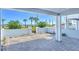 Back patio with a view of the beach and ocean, and decorated with palms and other Florida plants at 23 Marden Dr # 51, Ormond Beach, FL 32176