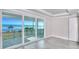 Bedroom with sliding glass doors leading to a balcony with ocean views and white trim, doors, and walls at 23 Marden Dr # 51, Ormond Beach, FL 32176