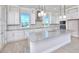 Bright kitchen featuring white cabinets, granite countertops, stainless steel appliances, and stylish pendant lighting at 23 Marden Dr # 51, Ormond Beach, FL 32176