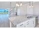 Open-concept kitchen with granite island, stainless steel sink, and views of the living area and ocean beyond at 23 Marden Dr # 51, Ormond Beach, FL 32176
