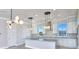 Contemporary kitchen featuring an island with granite countertops, pendant lights, and stainless steel appliances at 23 Marden Dr # 51, Ormond Beach, FL 32176
