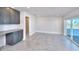 Living room with gray cabinets, granite countertop, tile flooring and access to the outside patio with sliding glass doors at 23 Marden Dr # 51, Ormond Beach, FL 32176
