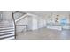 Open concept living space with stairs, tile flooring, and a view of the modern kitchen at 23 Marden Dr # 51, Ormond Beach, FL 32176