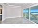 Main bedroom with white tray ceiling and sliding glass doors that open to a balcony with an ocean view at 23 Marden Dr # 51, Ormond Beach, FL 32176