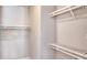 A walk-in closet that has wooden shelving for organization and white walls at 23 Marden Dr # 51, Ormond Beach, FL 32176