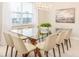 Bright dining room featuring a glass-top table, modern chairs, and a decorative light fixture at 7682 Fairfax Dr, Kissimmee, FL 34747