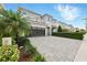 Suburban two-story home featuring a paved driveway and lush tropical landscaping at 7682 Fairfax Dr, Kissimmee, FL 34747