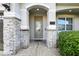 Close up of the front door with stone columns and a house number on the house at 7682 Fairfax Dr, Kissimmee, FL 34747