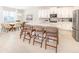 Modern kitchen with stainless steel appliances, white cabinets, a large island, and adjacent dining area at 7682 Fairfax Dr, Kissimmee, FL 34747