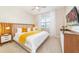 Cozy main bedroom with a comfortable bed, modern furnishings, and natural light at 7682 Fairfax Dr, Kissimmee, FL 34747